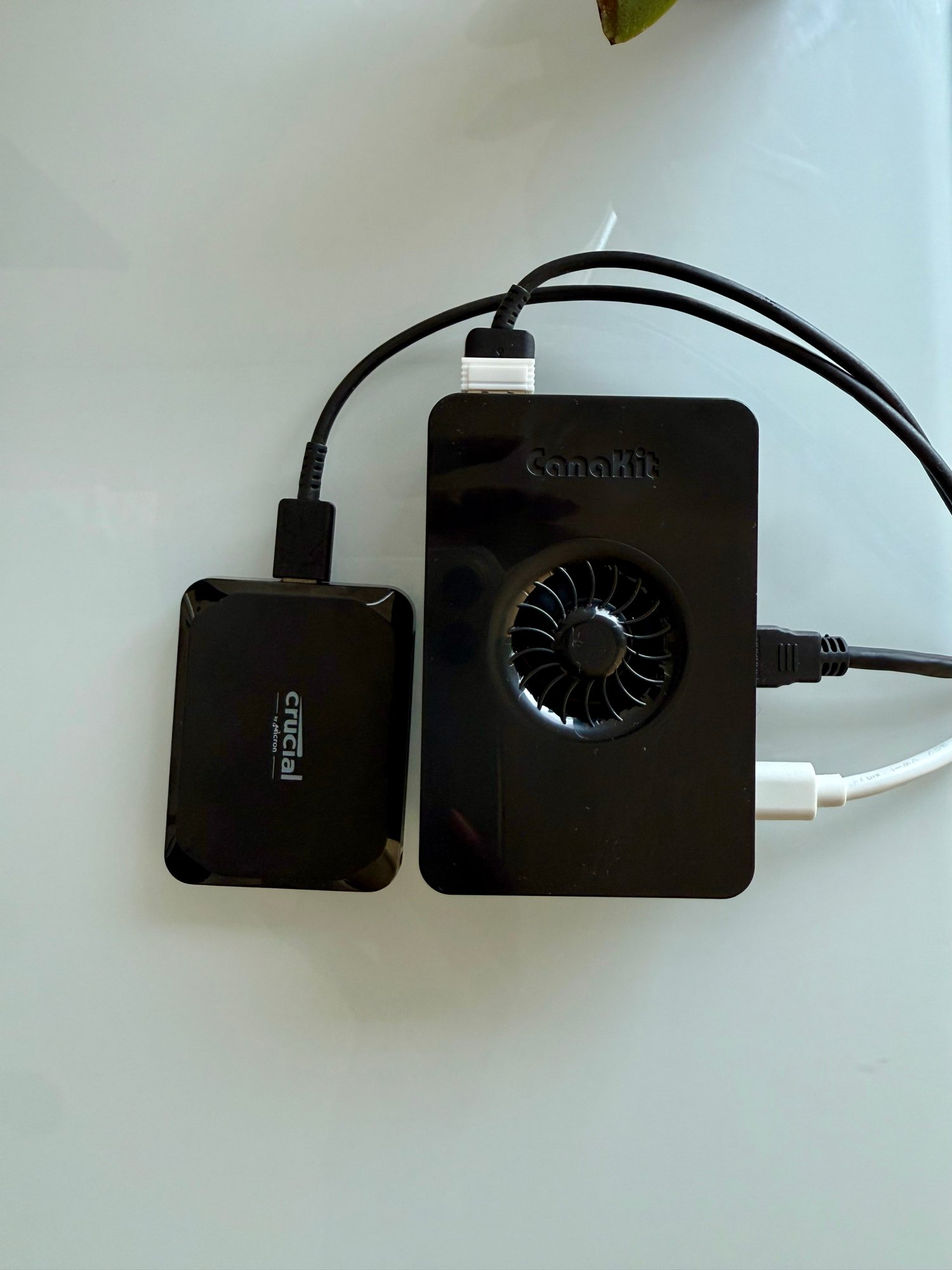 Raspberry Pi 5 in its CanaKit cooling case beside a Crucial X9 external SSD